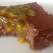 close up of a square piece of chocolate passion fruit fudge topped with bits of passion fruit seeds