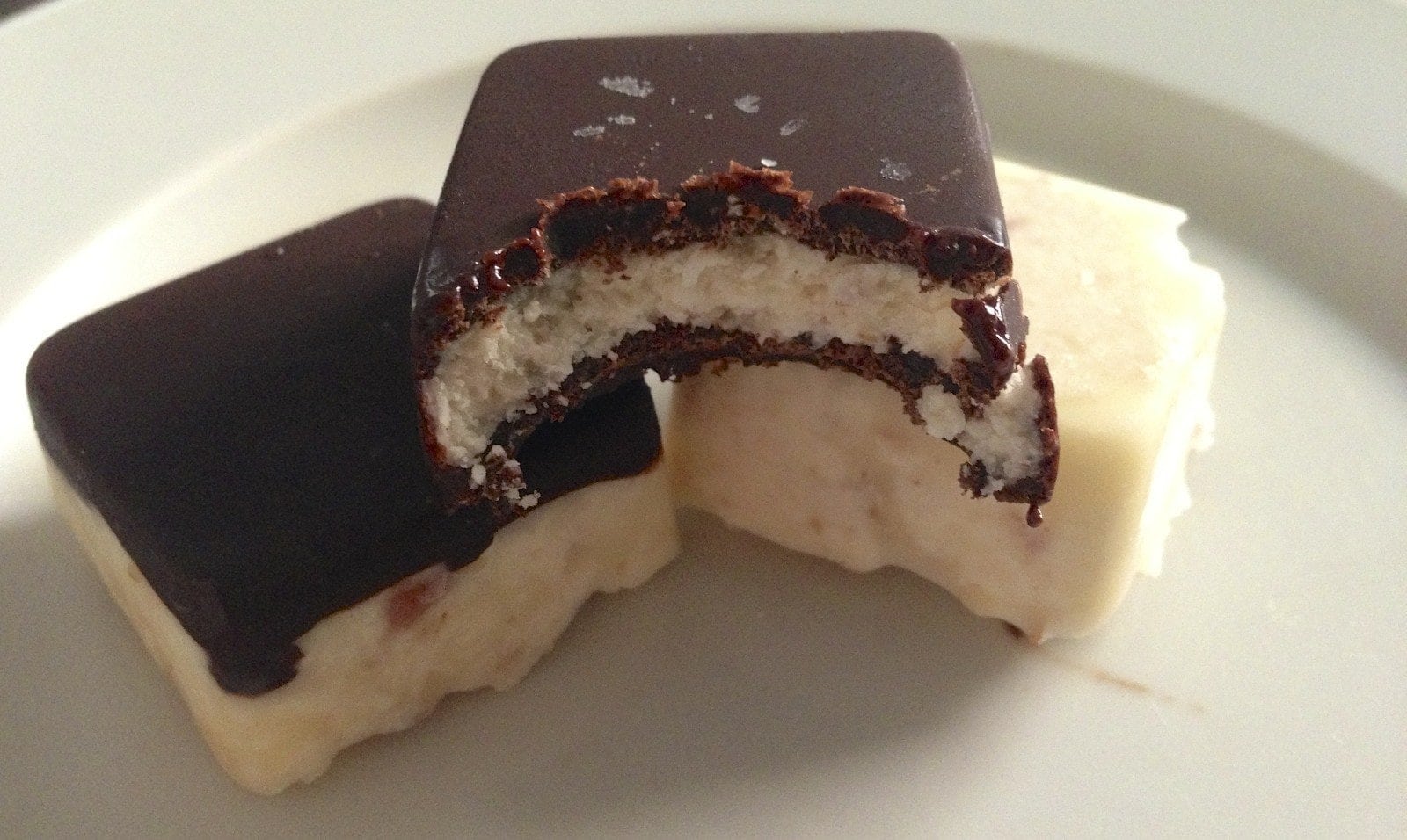 close up of several pieces of paleo cheesecake bites with one bitten into showing inside texture 