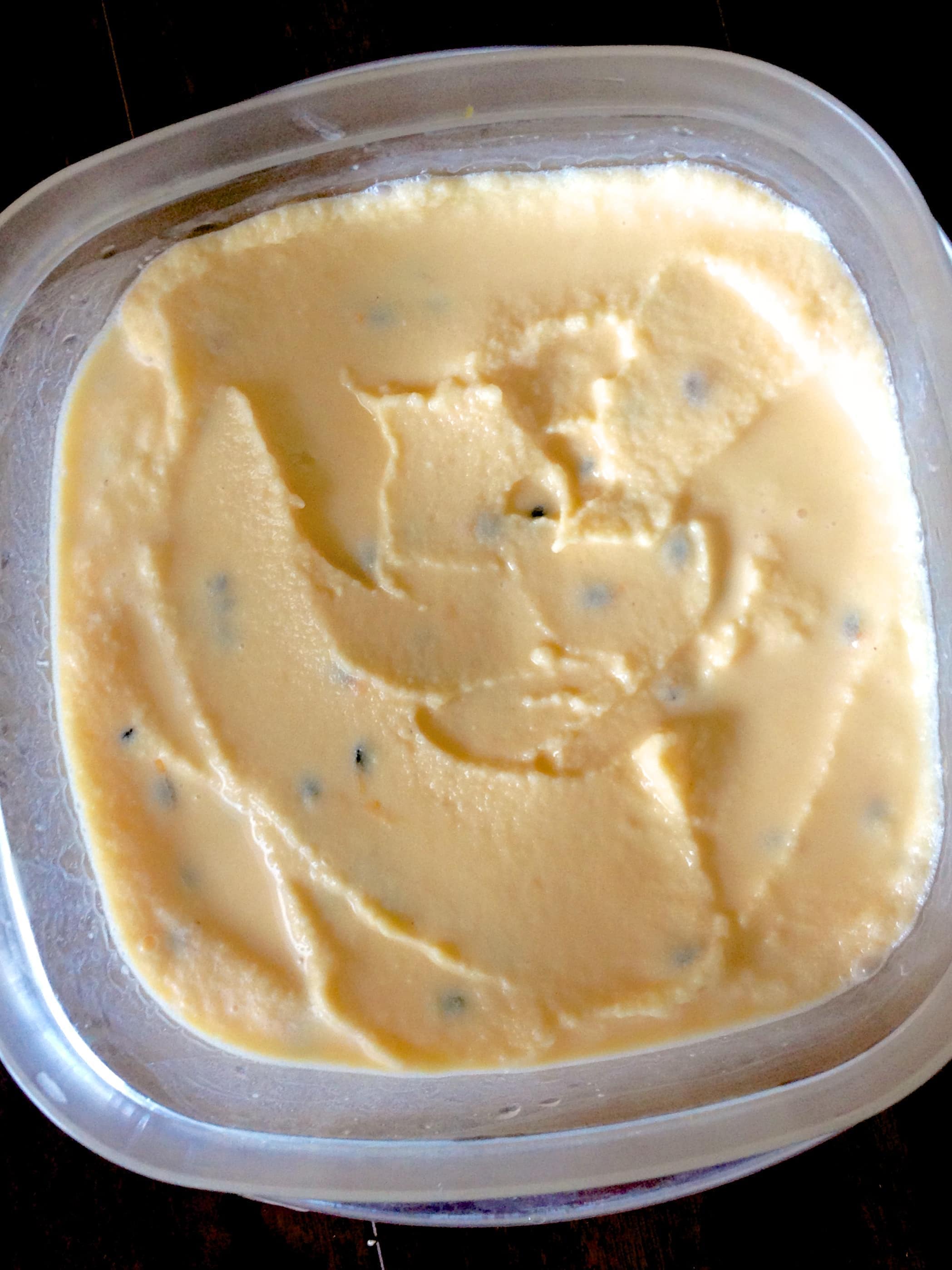 close up of a plastic dish of passion fruit ice cream 