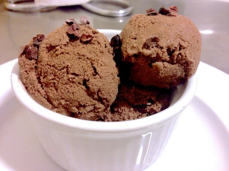 close up of a white dish filled with chocolate ice cream scoops