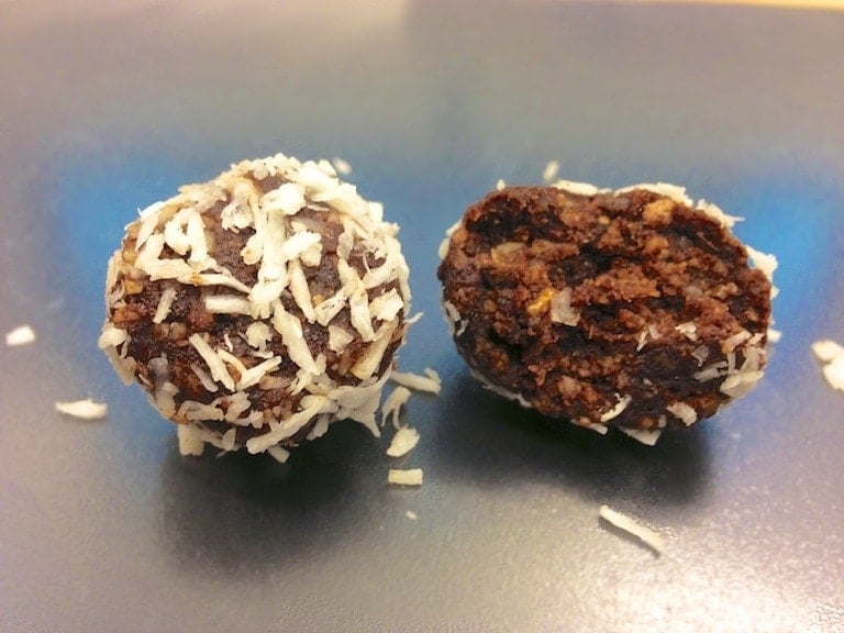 close up of two low carb paleo chocolate truffles with one piece opened up showing inside texture  