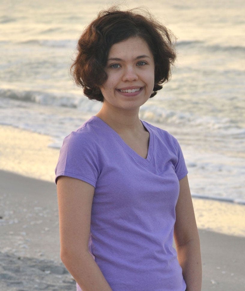 A woman standing on a beach
