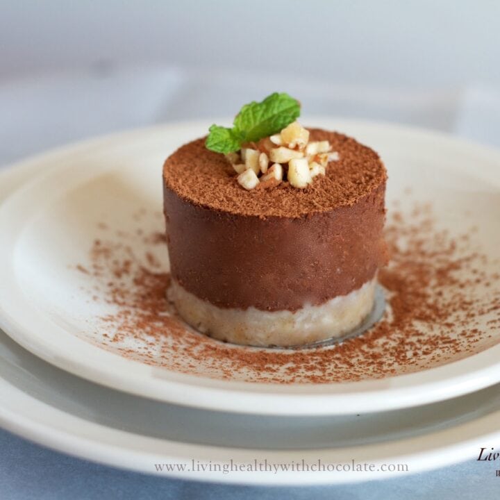 single serving of paleo chocolate pie dusted in cacao powder topped with chopped nuts and fresh mint