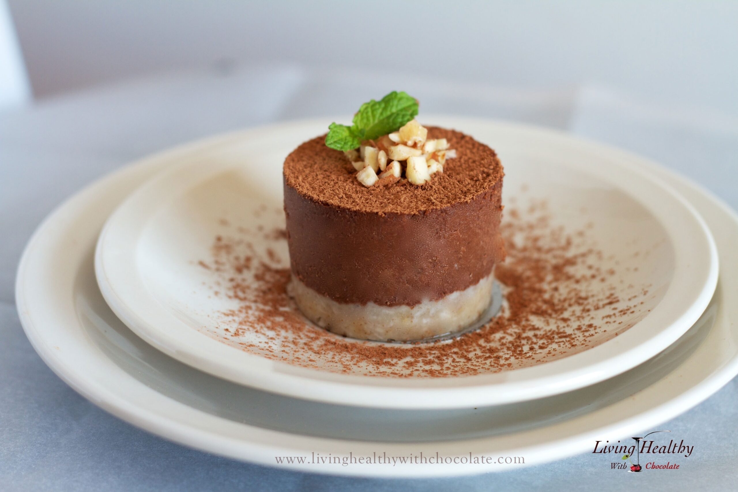 single serving of paleo chocolate pie dusted in cacao powder topped with chopped nuts and fresh mint