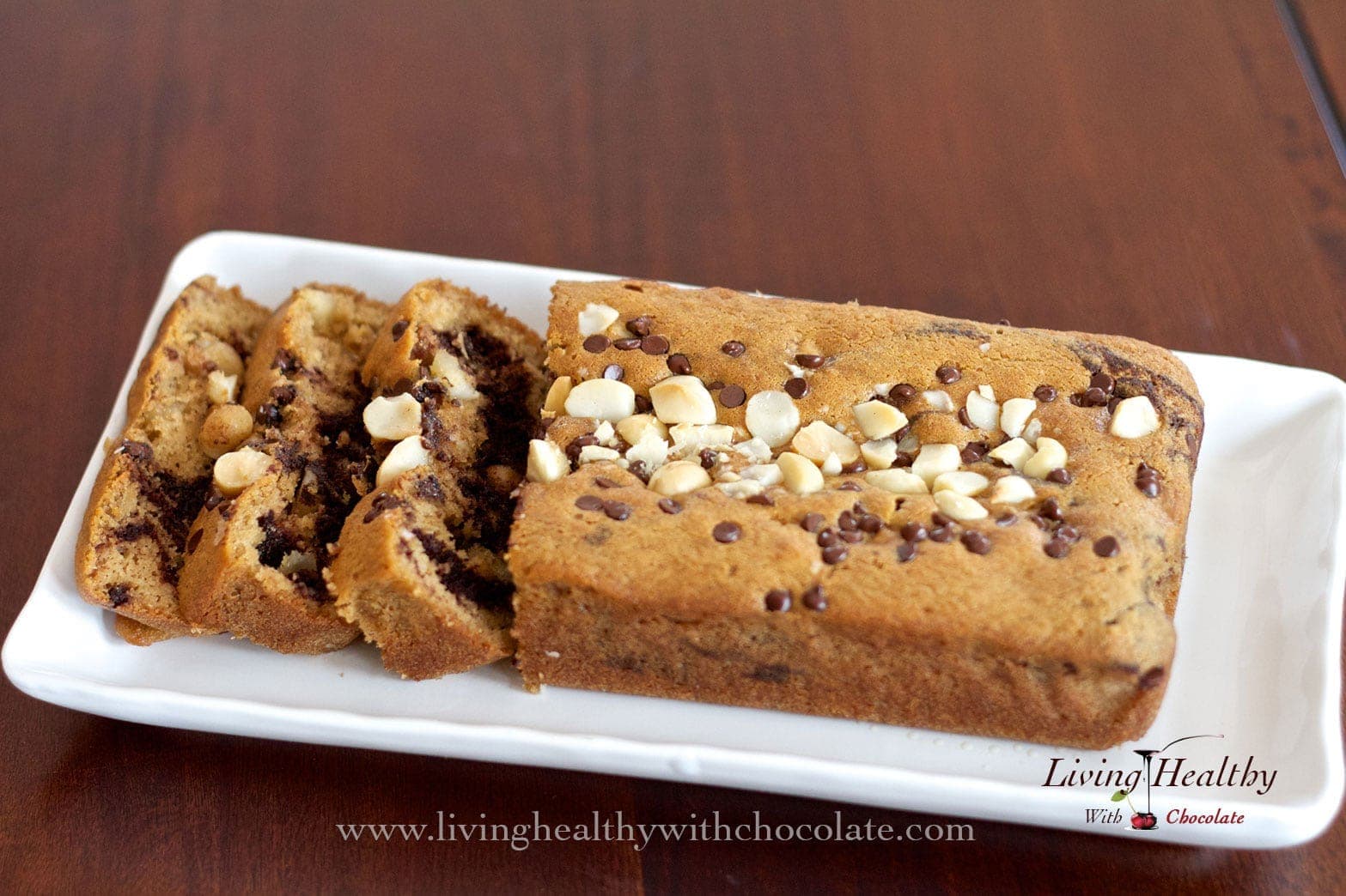 loaf of paleo marble cake on a wooden table with a few slices cut 