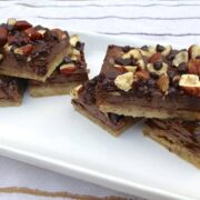 tray of paleo chocolate hazelnut cookie bars topped with chopped nuts