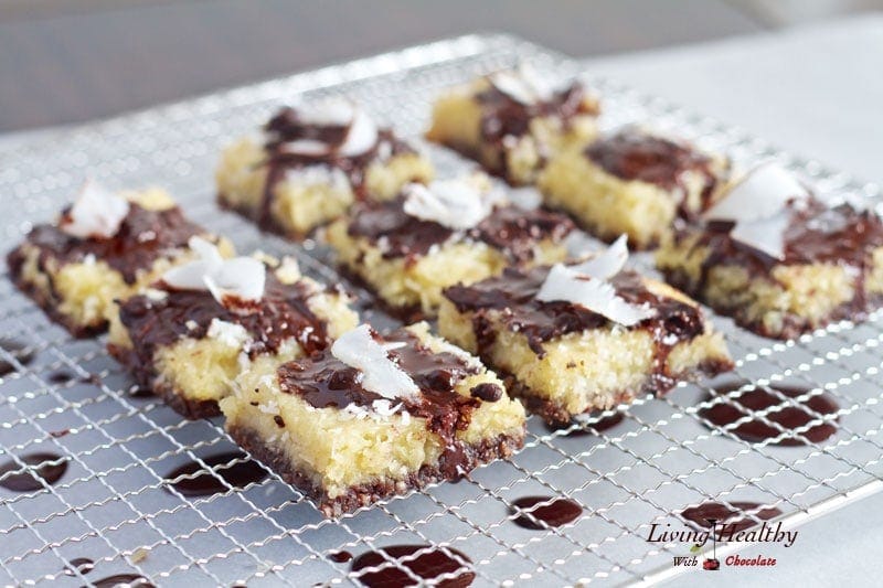 paleo coconut brownie bars drizzled with chocolate cooling on a wire rack