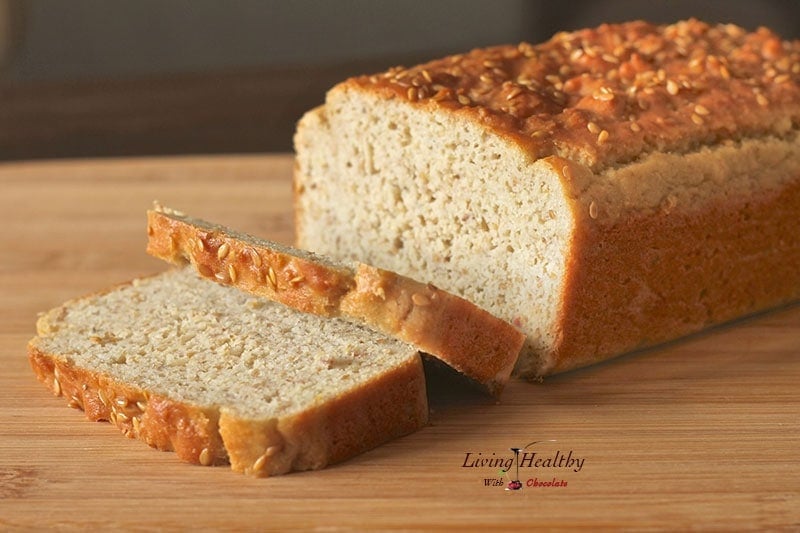 loaf of homemade paleo sandwich bread on cutting board with two slices cut