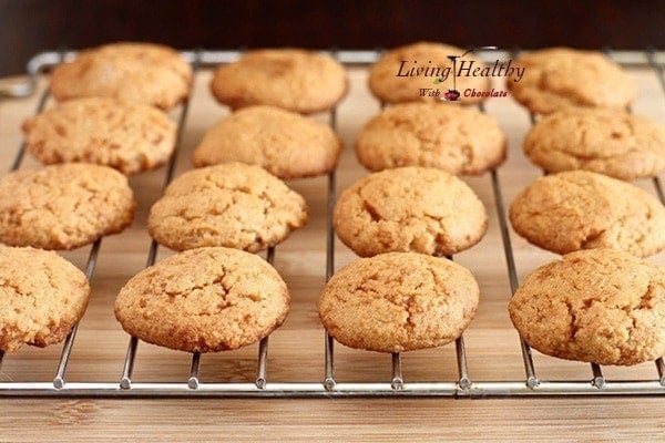 wire rack with rows of almond cookies 