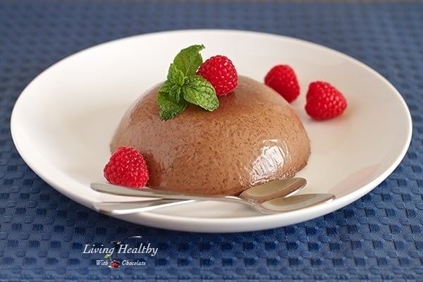 plate with paleo chocolate Raspberry panna cotta dessert topped with fresh raspberries 