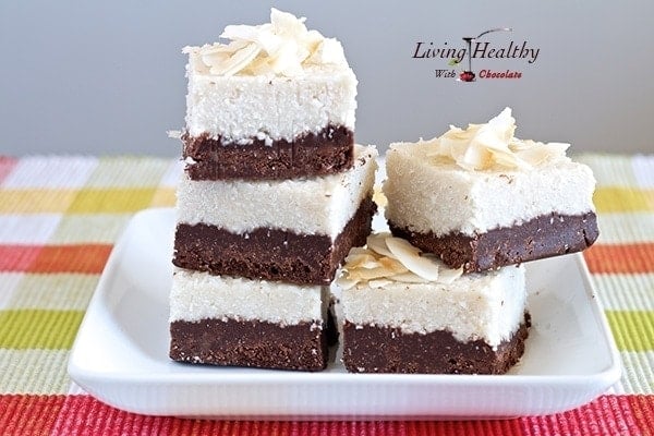 plate with stacks of coconut fudge bars on a colorful yellow and red placemat