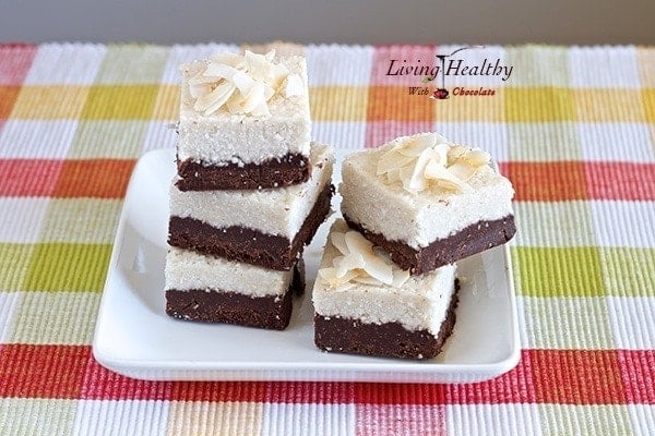 plate with stacks of coconut fudge bars on a colorful yellow and red placemat