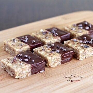 wooden cutting board with several paleo nut krispy treats lined up