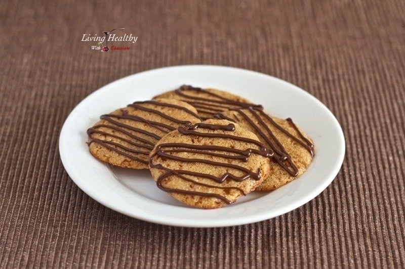 round plate with four paleo soft and chewy butter cookies drizzled with chocolate