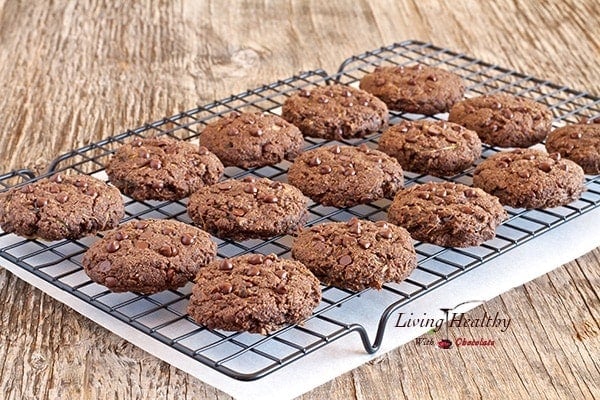 wire cooling rack on wooden table with rows of chocolate chip zucchini cookies