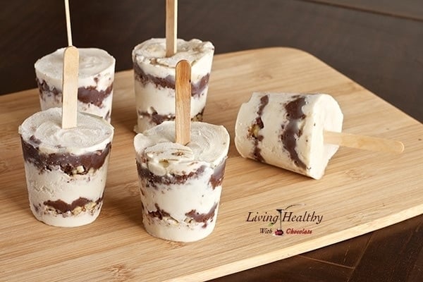 paleo nutella layered ice cream pops with popsicle stick on wooden table 