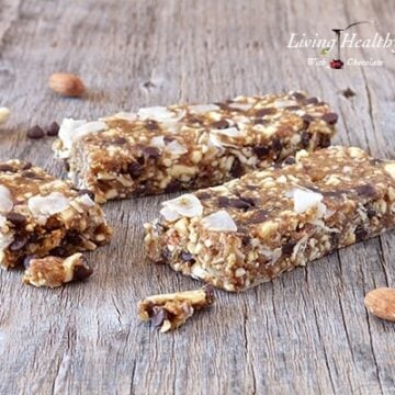 two bars of paleo chocolate chip cookie dough granola bars on a wooden table