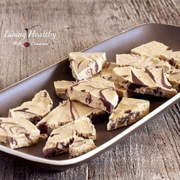 brown serving plate with coconut peanut butter chocolate swirl bark cut into pieces