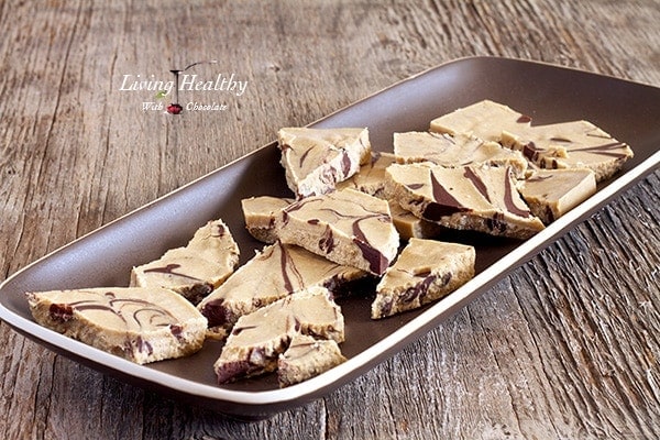 brown serving plate with coconut peanut butter chocolate swirl bark cut into pieces 