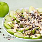 close up of a plate of apple nachos for dessert topped with chocolate and shredded coconut and sliced almonds