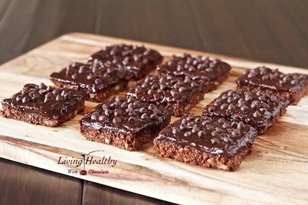 wooden tray with rows of double chocolate espresso bars topped with chocolate chips