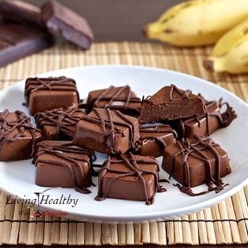 plate with numerous squares of frozen peanut butter Chocolate banana fudge bites drizzled in chocolate