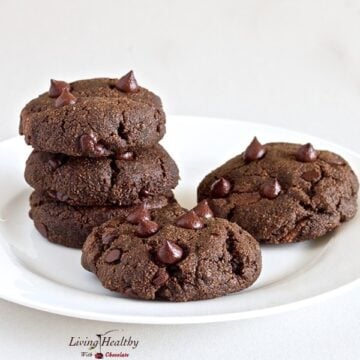 close up of five homemade nutella filled double chocolate chip cookies on white plate