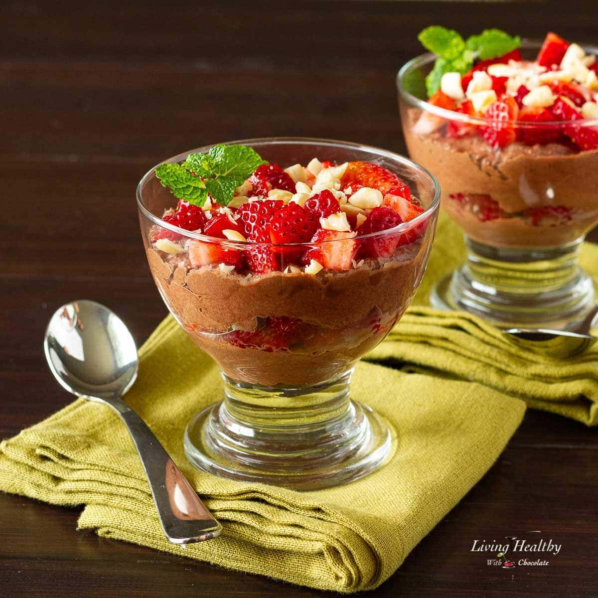 glass serving dishes with chocolate parfait topped with strawberries