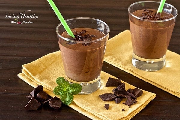 creamy thick mint chocolate milkshake on yellow napkin with bits of chocolate and piece of mint