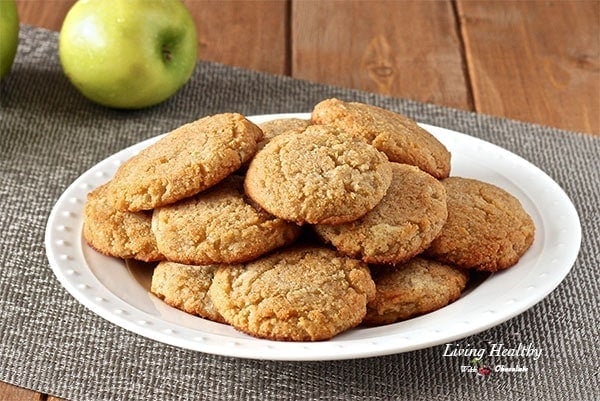 apple cookies stacked on a white plate