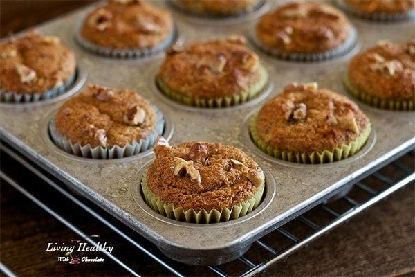 close up of a muffin tin with banana walnut breakfast muffins cooling on a wire rack