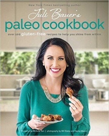 Juli Bauers Paleo cookbook cover with Juli Bauers smiling for the camera holding up some food in her hand