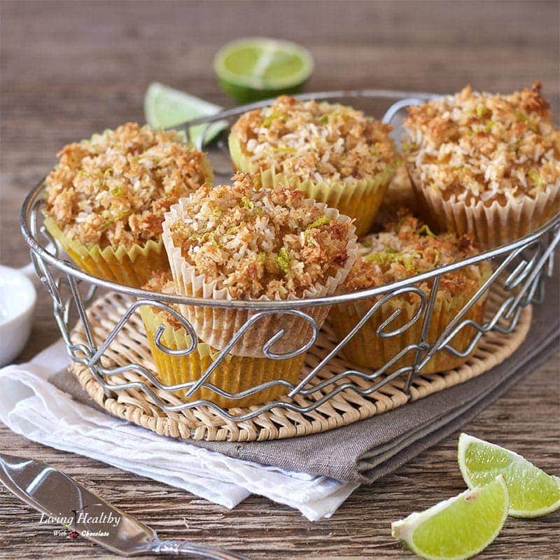 basket filled with mango muffins topped with coconut lime streusel and slices of lime around the basket