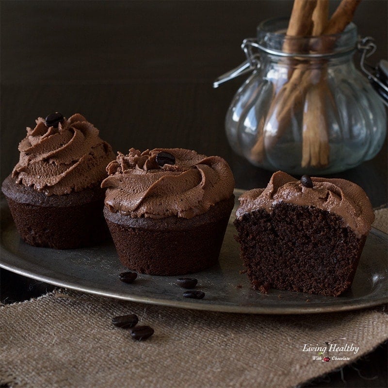 tray of cinnamon mocha cupcakes with a glass jar filled with cinnamon sticks in background