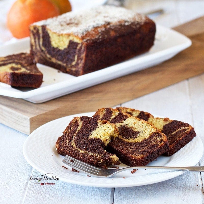 Three slices of cake on a plate with one bite taking off