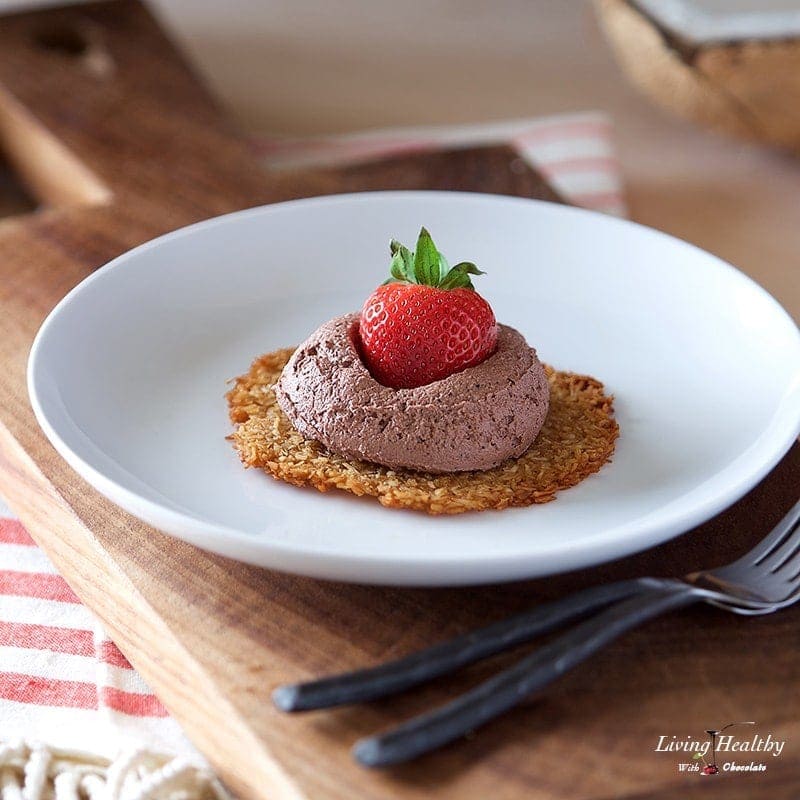 dish with coconut tulles dessert topped with fresh strawberries and chocolate whipping cream