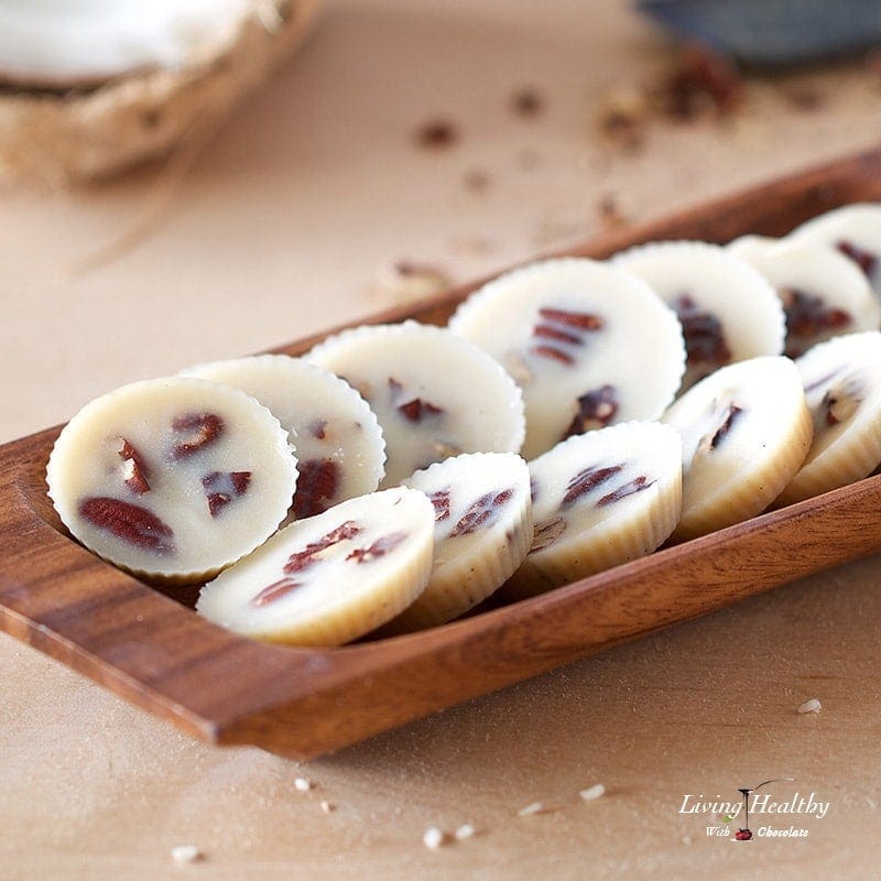 wooden dish with numerous coconut praline chips and coconut in background