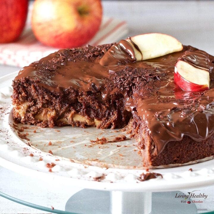 Apple chocolate cake topped with slices of apple and drizzled in chocolate sauce