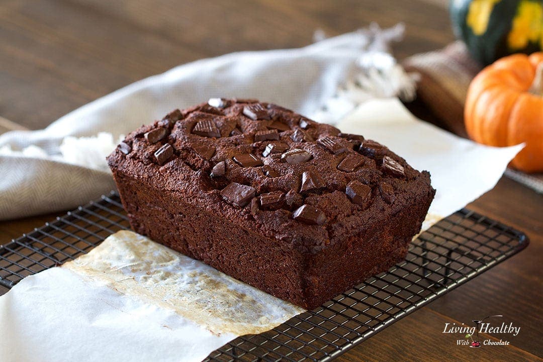 Loaf of chocolate pumpkin bread cooling on a wire cooling rack