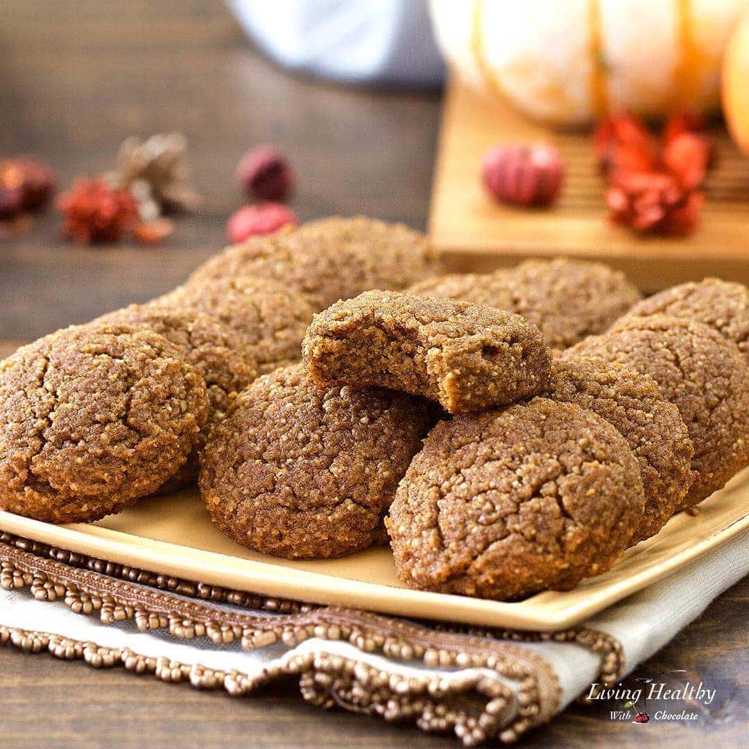 a plate of pumpkin cookies with holiday decorations in the background 