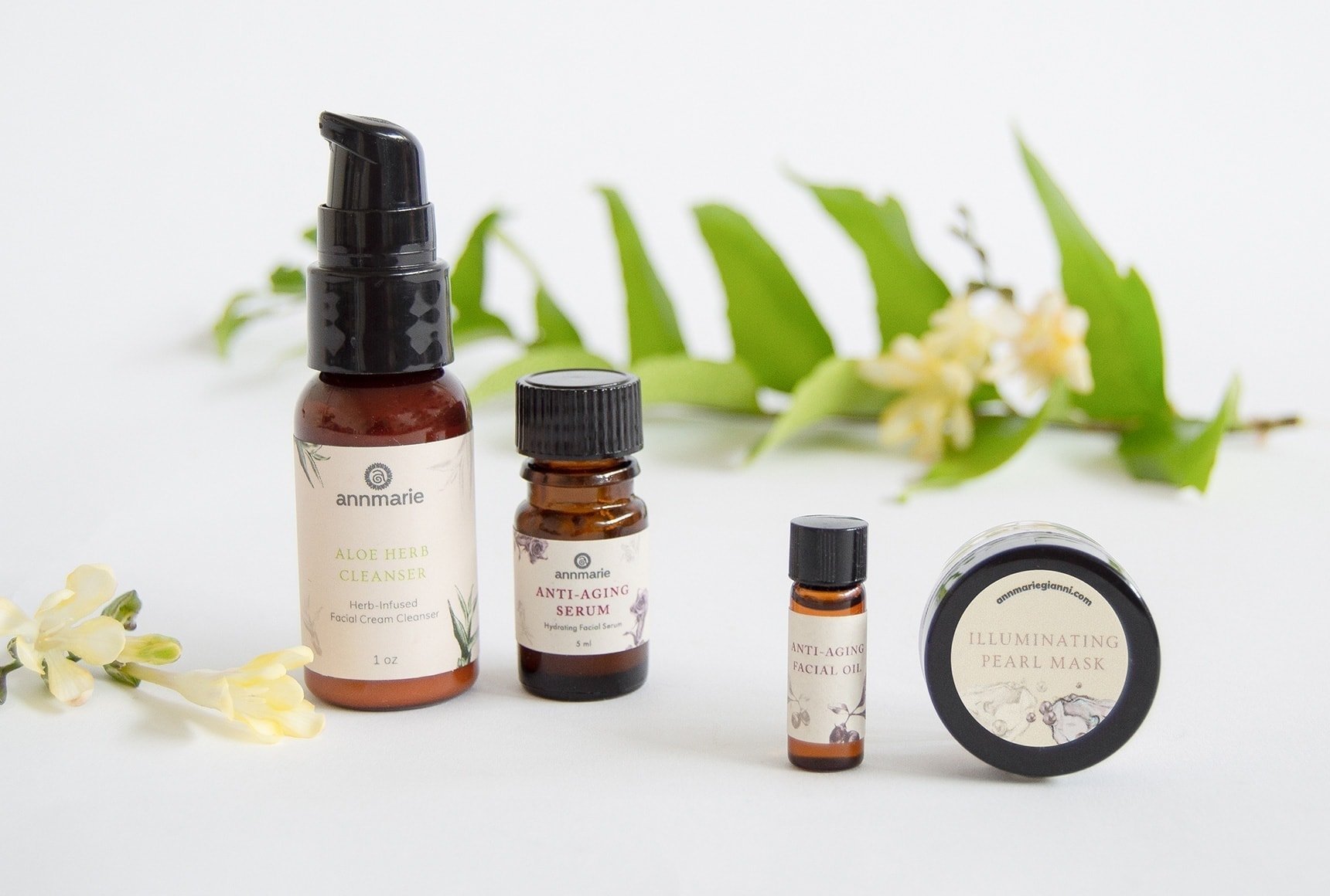 four safer skincare products on a table with a green leaf in the background