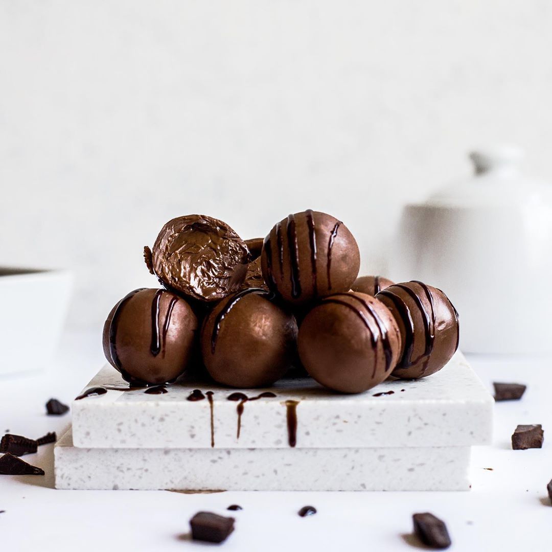 stack of chocolate hazelnut cream filled truffles with a white background 