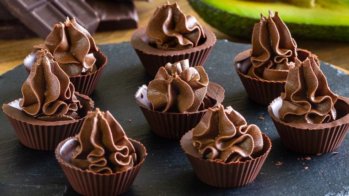 Avocado Chocolate Mousse in Chocolate Cups on a black plate