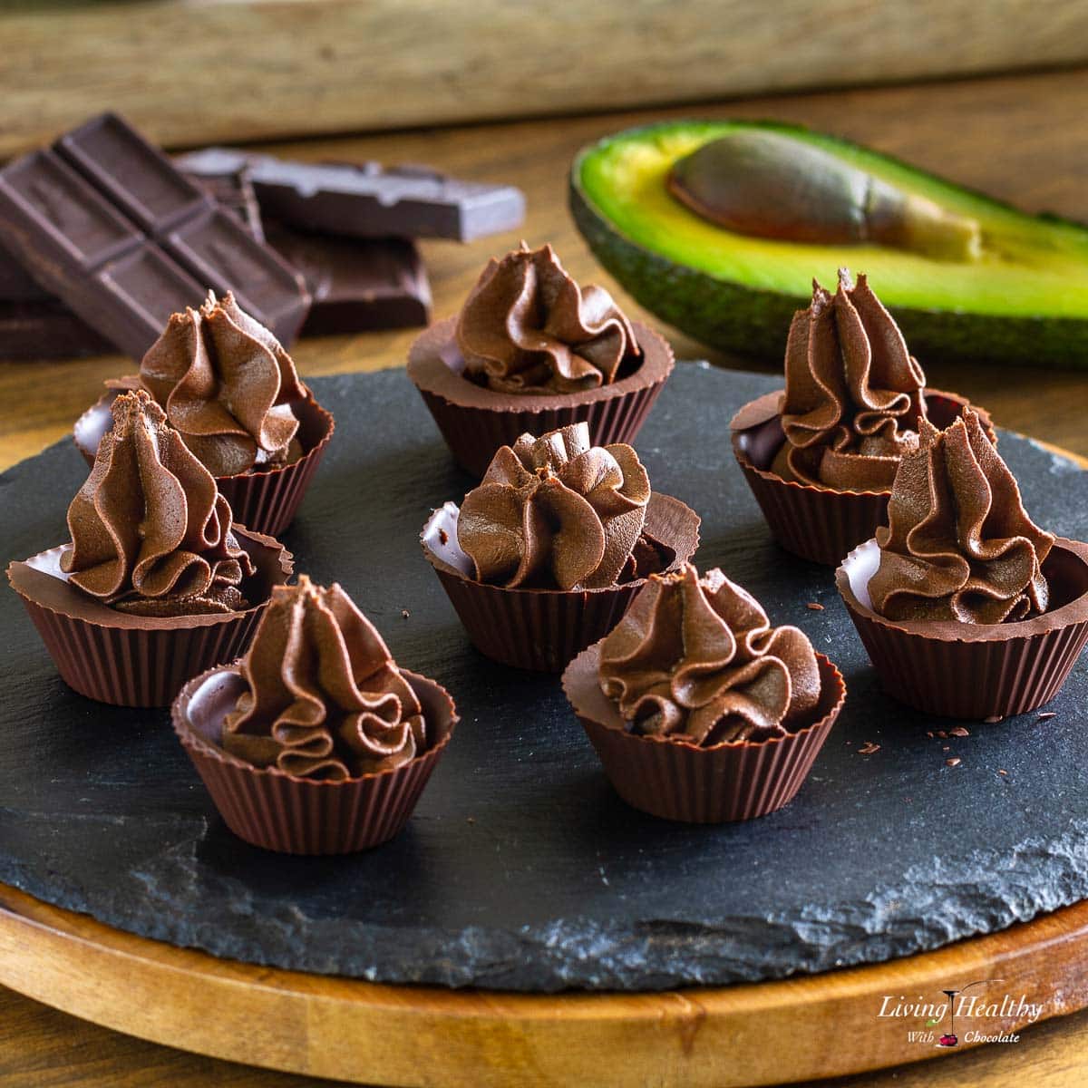 Avocado Chocolate Mousse in Chocolate Cups on a black plate