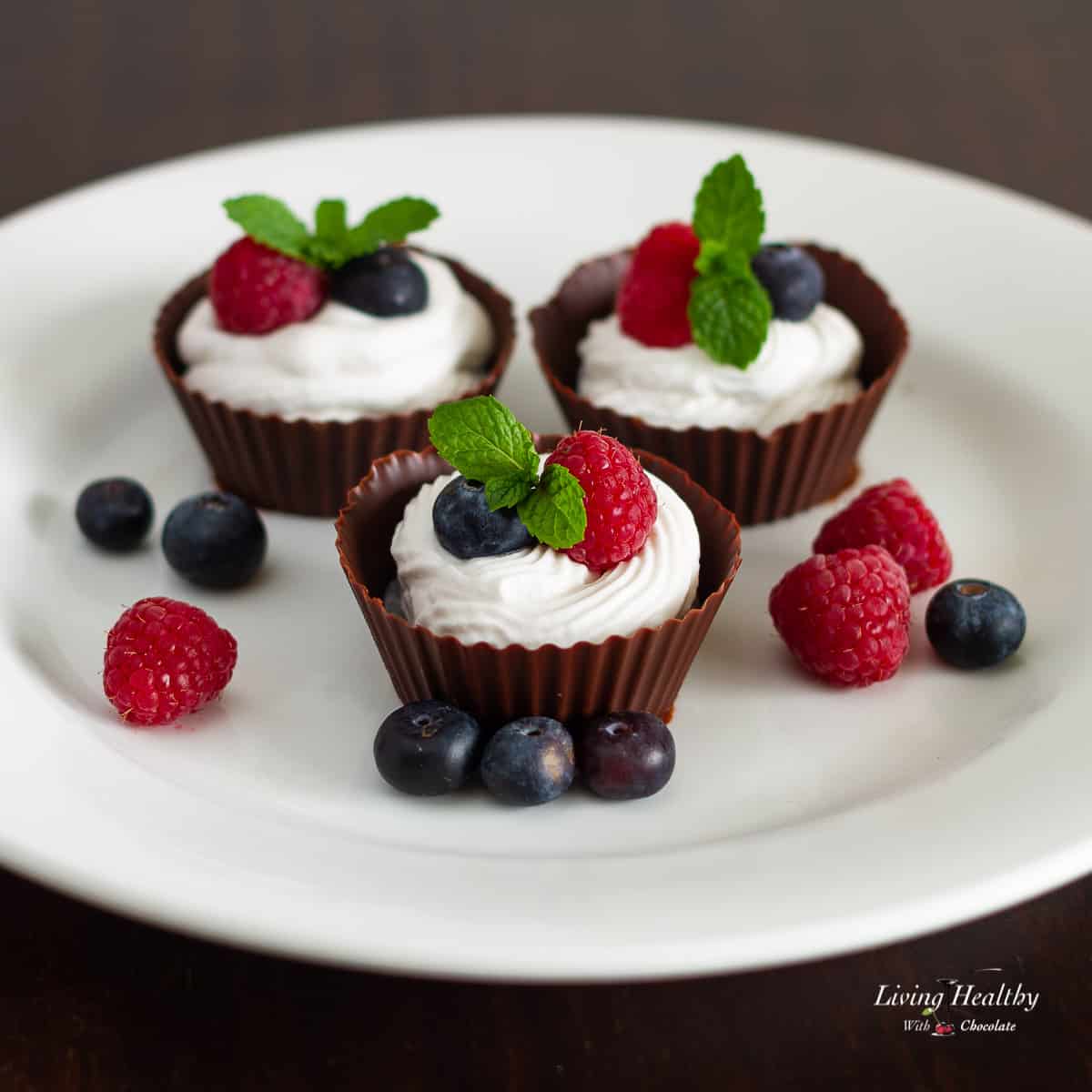 Chocolate cups filled with coconut cream and fresh berries.