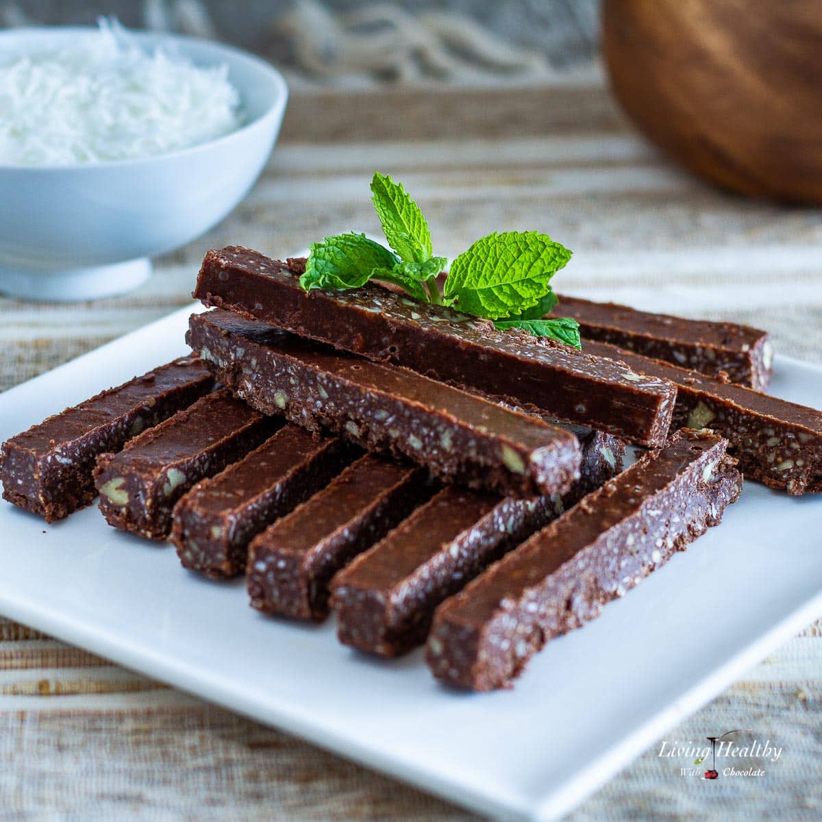 plate stacked with peppermint chocolate sticks and a bowl of shredded coconut in background 