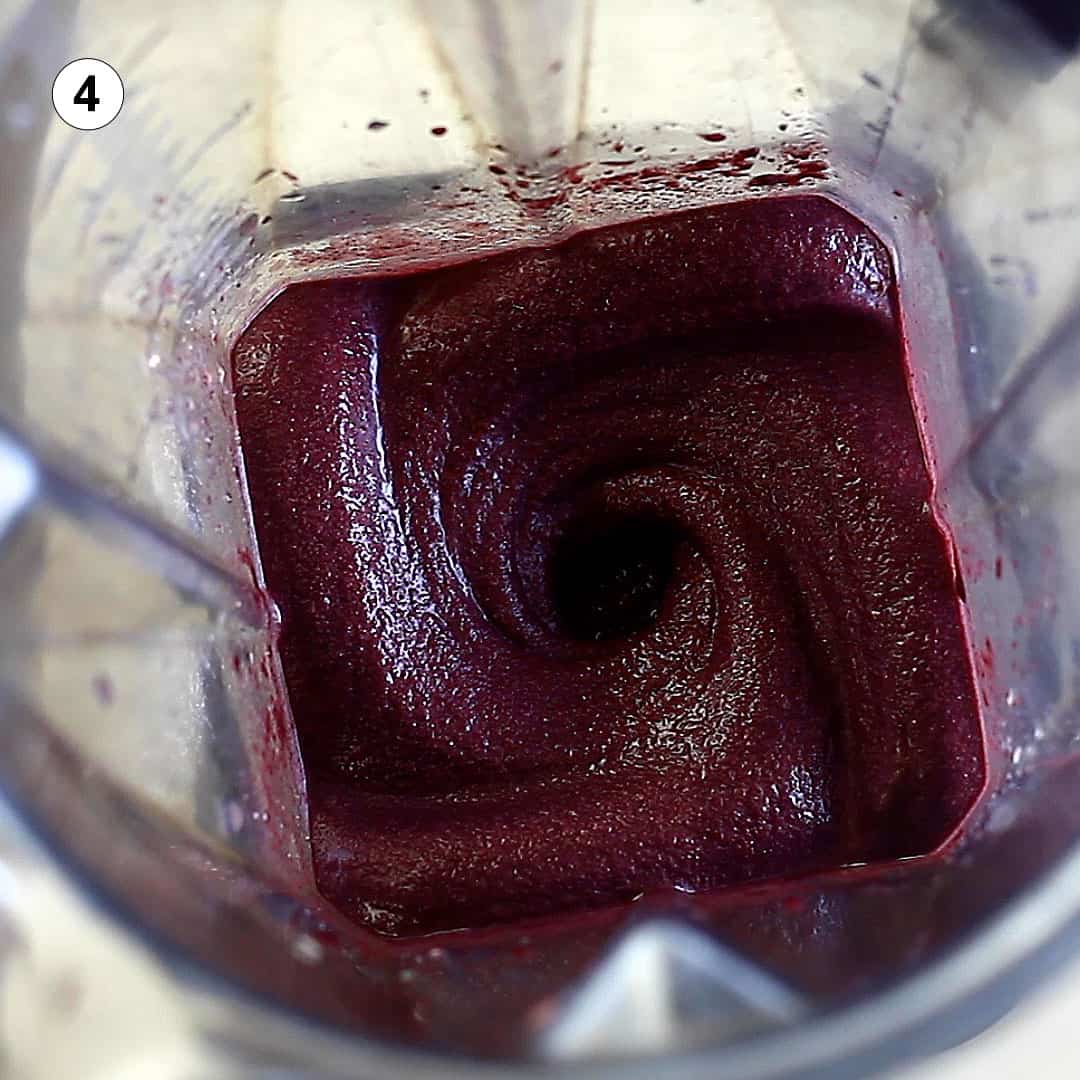 close up the inside of a blender containing freshly made acai